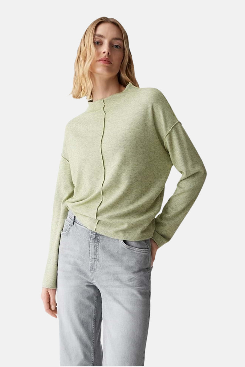 Pull à col rond vert par OPUS, avec couture centrale verticale et porté avec un jean gris.