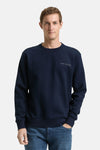 Blauwe sweater van Tom Tailor, gedragen met een blauwe jeans en witte sneakers.