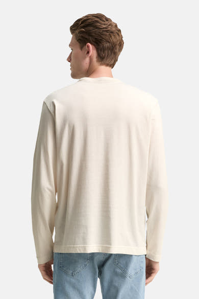 Witte T-shirt met lange mouwen van Tom Tailor, gedragen met een lichtblauwe jeans, achtergezicht.