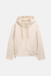 Korte beige jas van Tom Tailor, doorgestikt patroon met gladde en gewatteerde textuur.