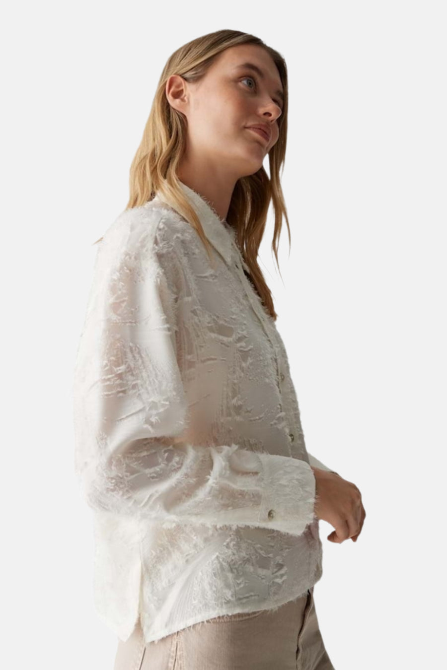 Chemise à manches longues beige d'OPUS, texturée, portée avec un pantalon couleur sable en vue latérale.