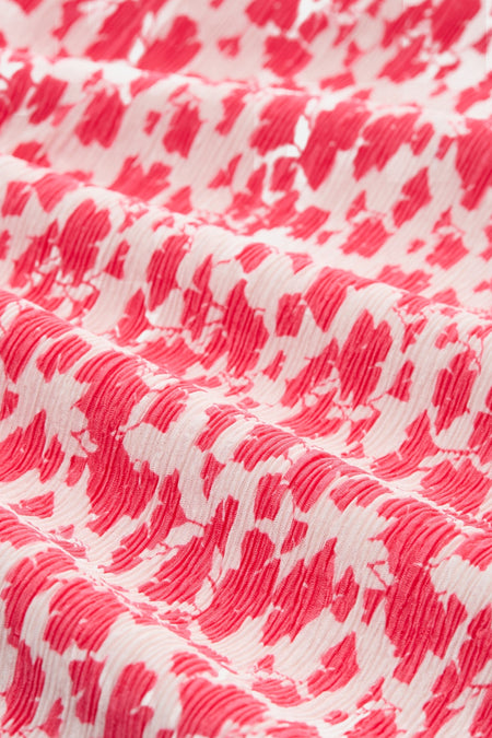 Jupe 3/4 rose et blanche de Tom Tailor avec motif abstrait plissé.