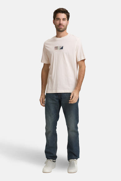 T-shirt à manches courtes blanc de Tom Tailor, avec un motif géométrique sur le devant, porté avec un jean et des baskets.
