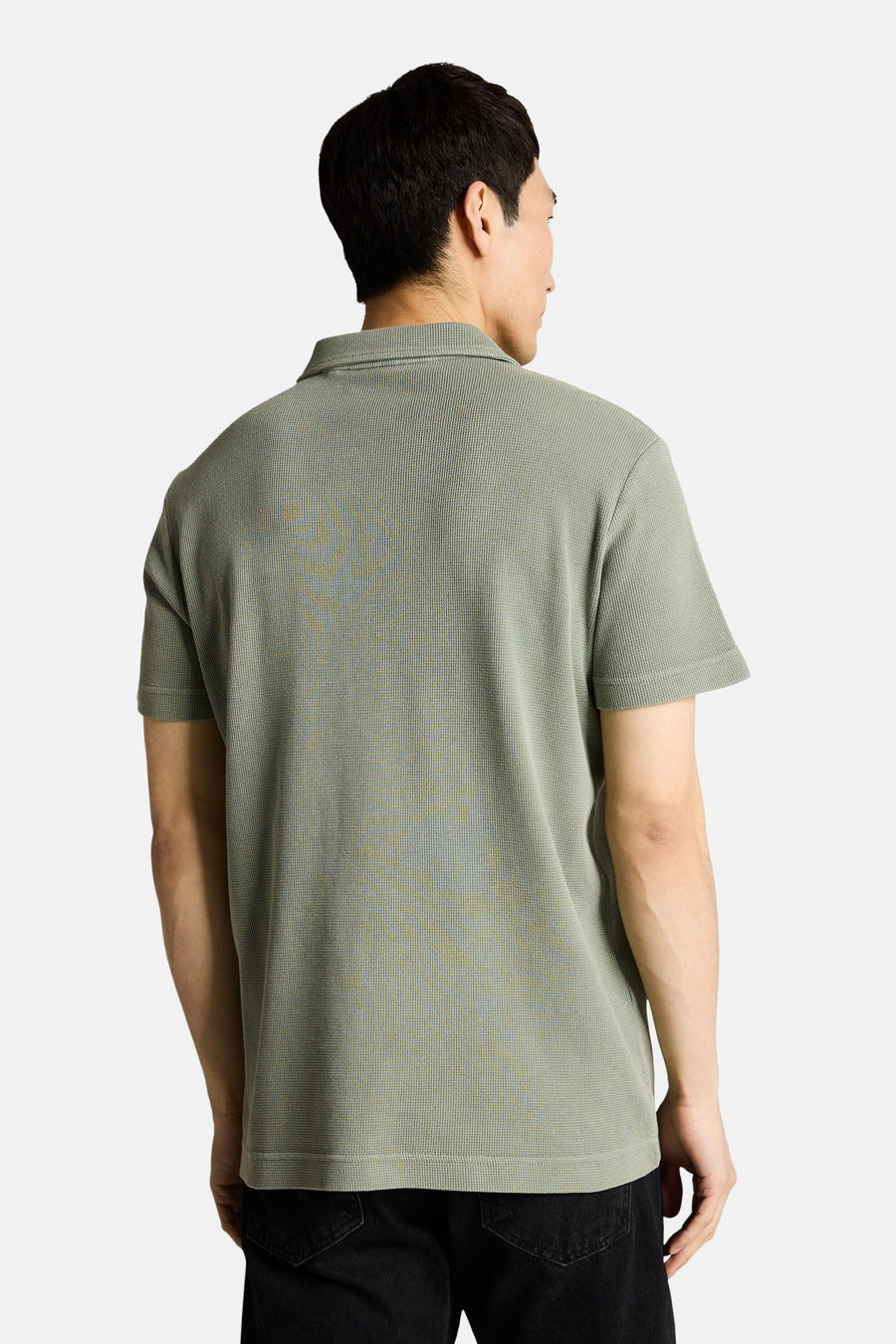 Tom Tailor fijngebreide poloshirt, van achteren gezien op een man met een zwarte broek.