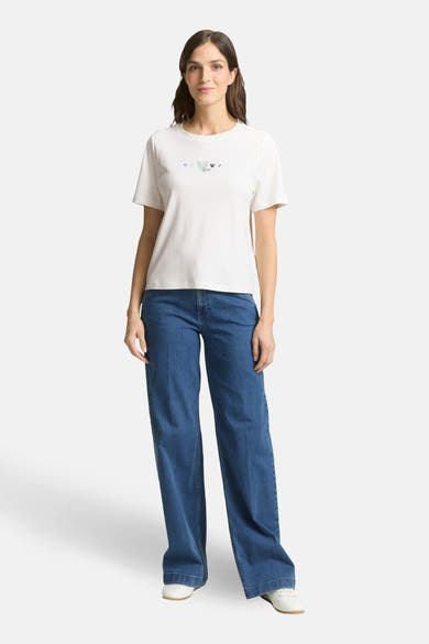 T-shirt blanc à manches courtes de Tom Tailor, avec un motif de coeurs décoratifs. Porté avec un jean ample.