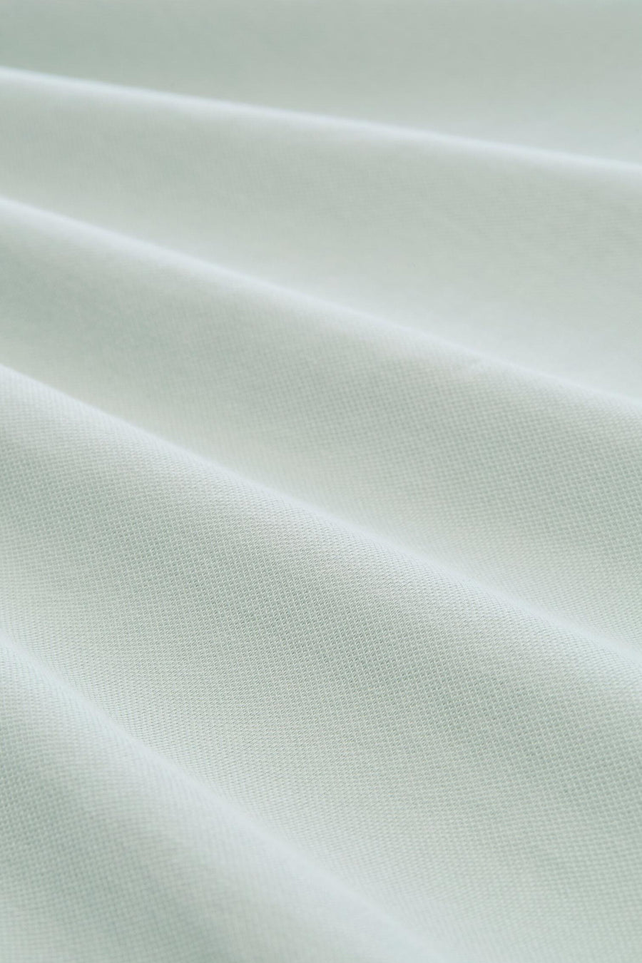 Polo vert pâle de Tom Tailor, en tissu piqué texturé avec des plis doux.