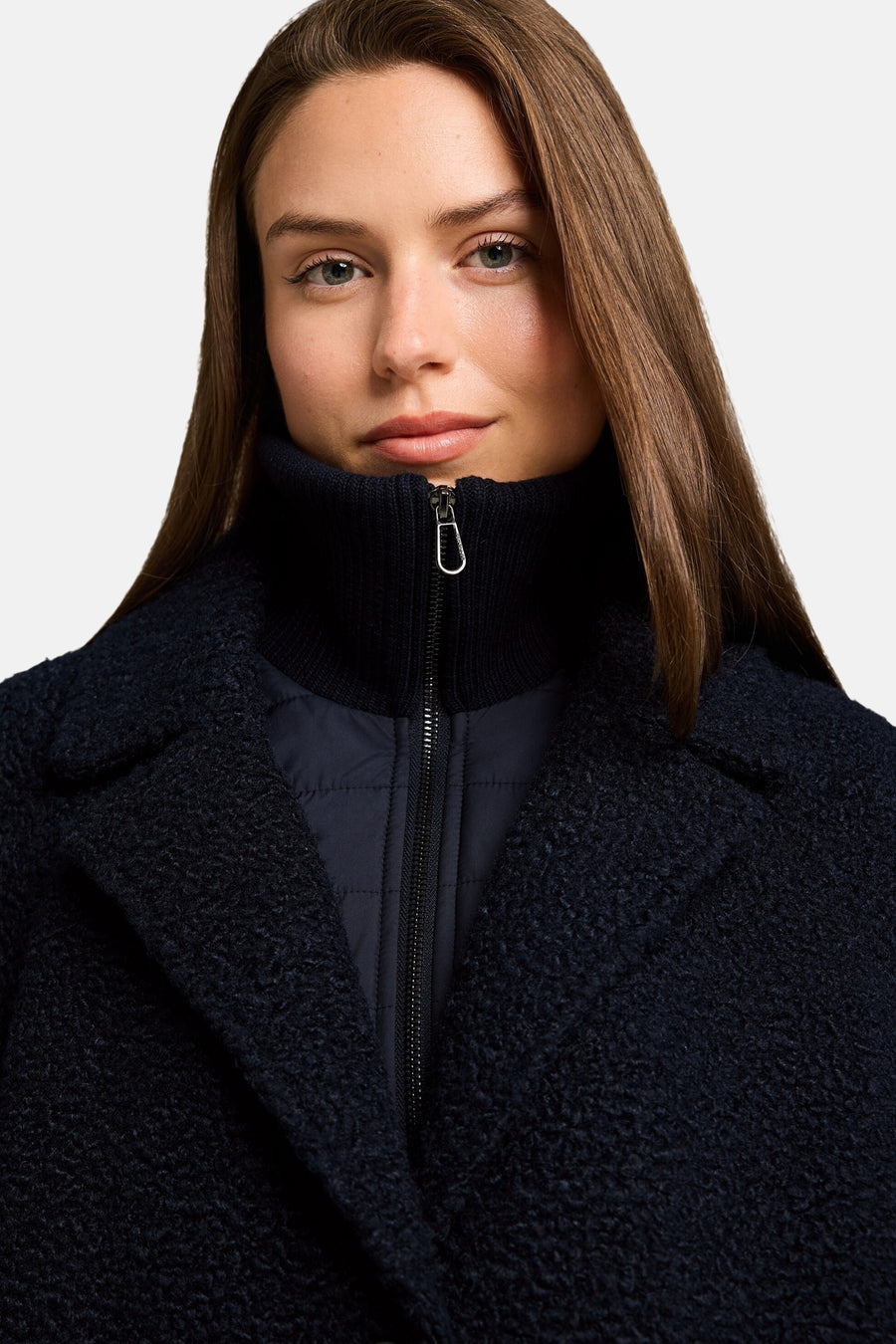 Navy blue textured poncho with high ribbed collar and front zipper, cropped front view showing quilted lining