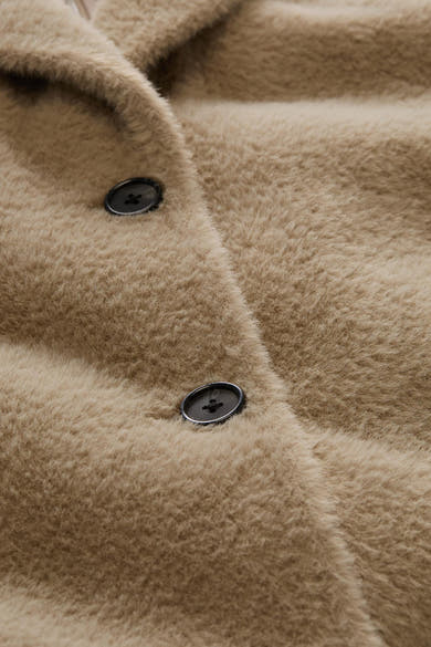 Taupe fuzzy poncho with black buttons, close-up front view showing soft texture and plush material