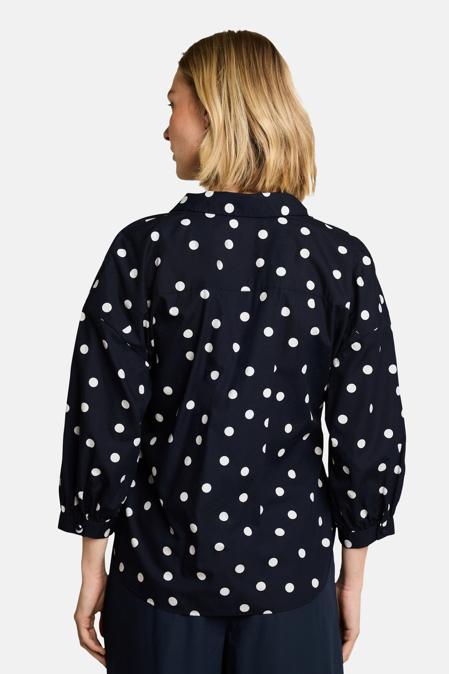 Navy blue short-sleeve blouse with white polka dots by Tom Tailor, back view, featuring gathered sleeves and relaxed fit