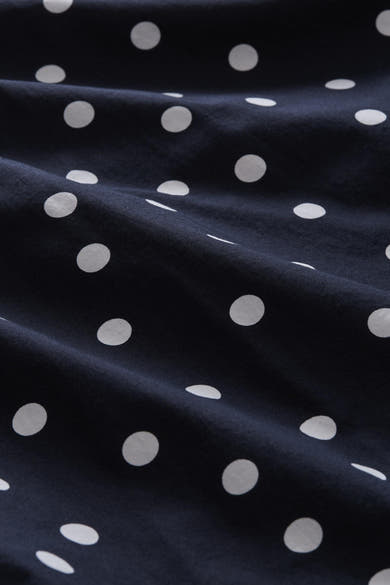 Navy blue short-sleeve blouse with white polka dots by Tom Tailor, close-up fabric texture view
