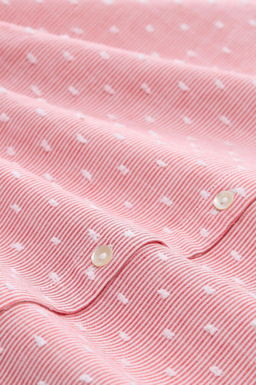 Red long-sleeve blouse with white pinstripes and dot details by Tom Tailor, featuring cream buttons and textured fabric in close-up view