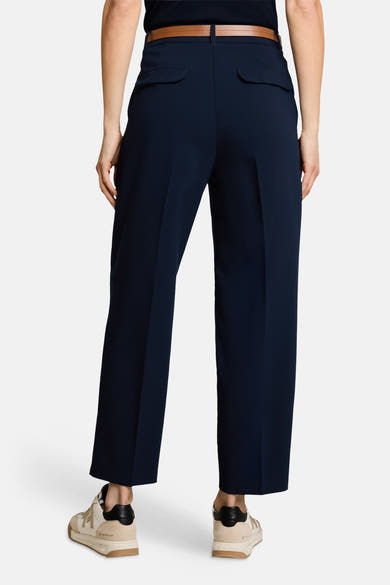 Navy blue tailored suit pants by Tom Tailor, back view with slim fit, side pockets, and brown belt, paired with beige sneakers.