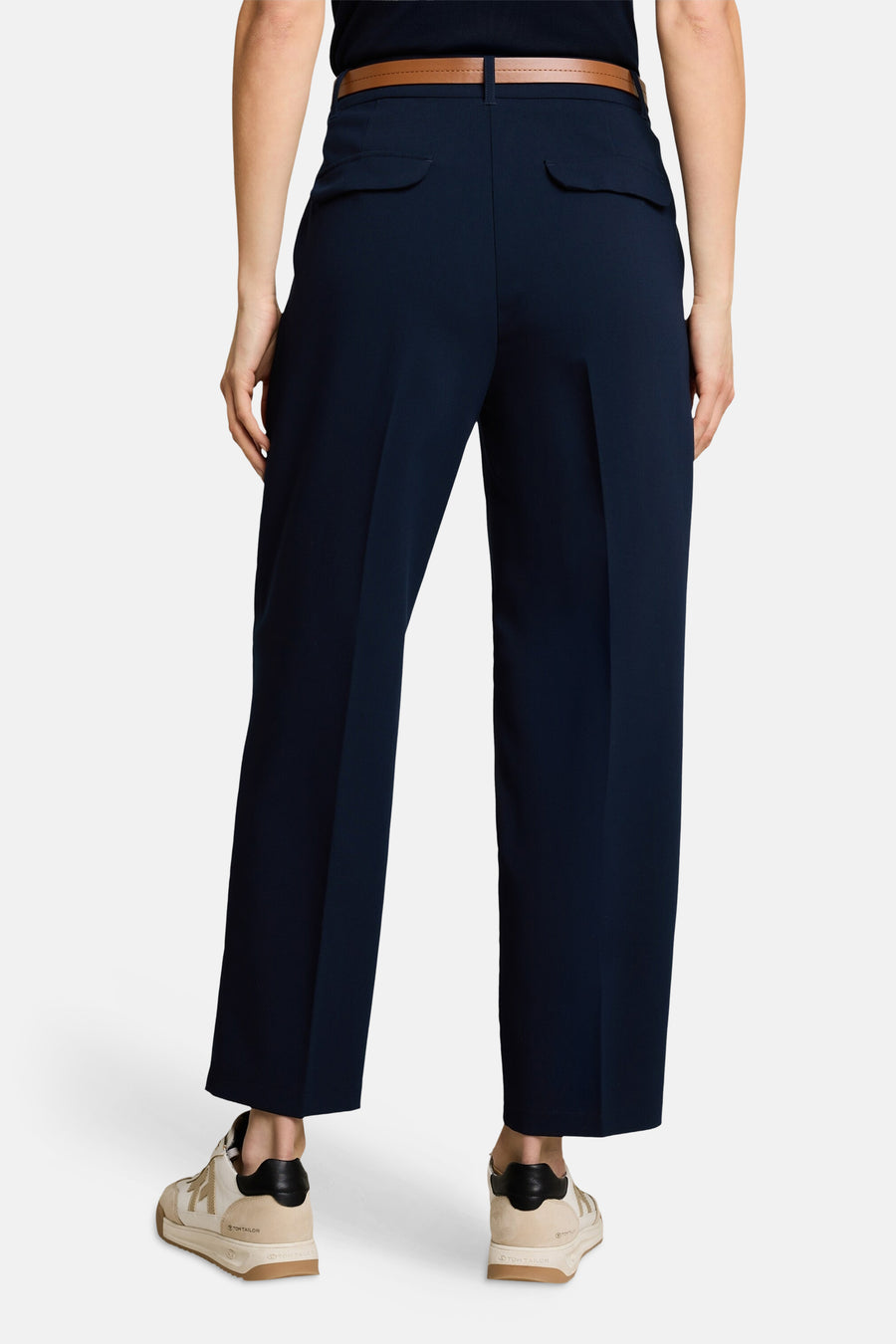 Navy blue tailored suit pants by Tom Tailor, back view with slim fit, side pockets, and brown belt, paired with beige sneakers.