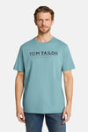 Blue short-sleeve T-shirt by Tom Tailor with bold logo print and casual fit, worn with dark jeans in front view.