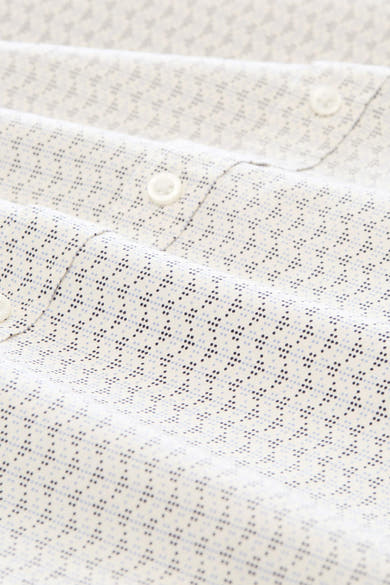 White long-sleeve shirt with subtle blue and black dot pattern, close-up view of collar and buttons