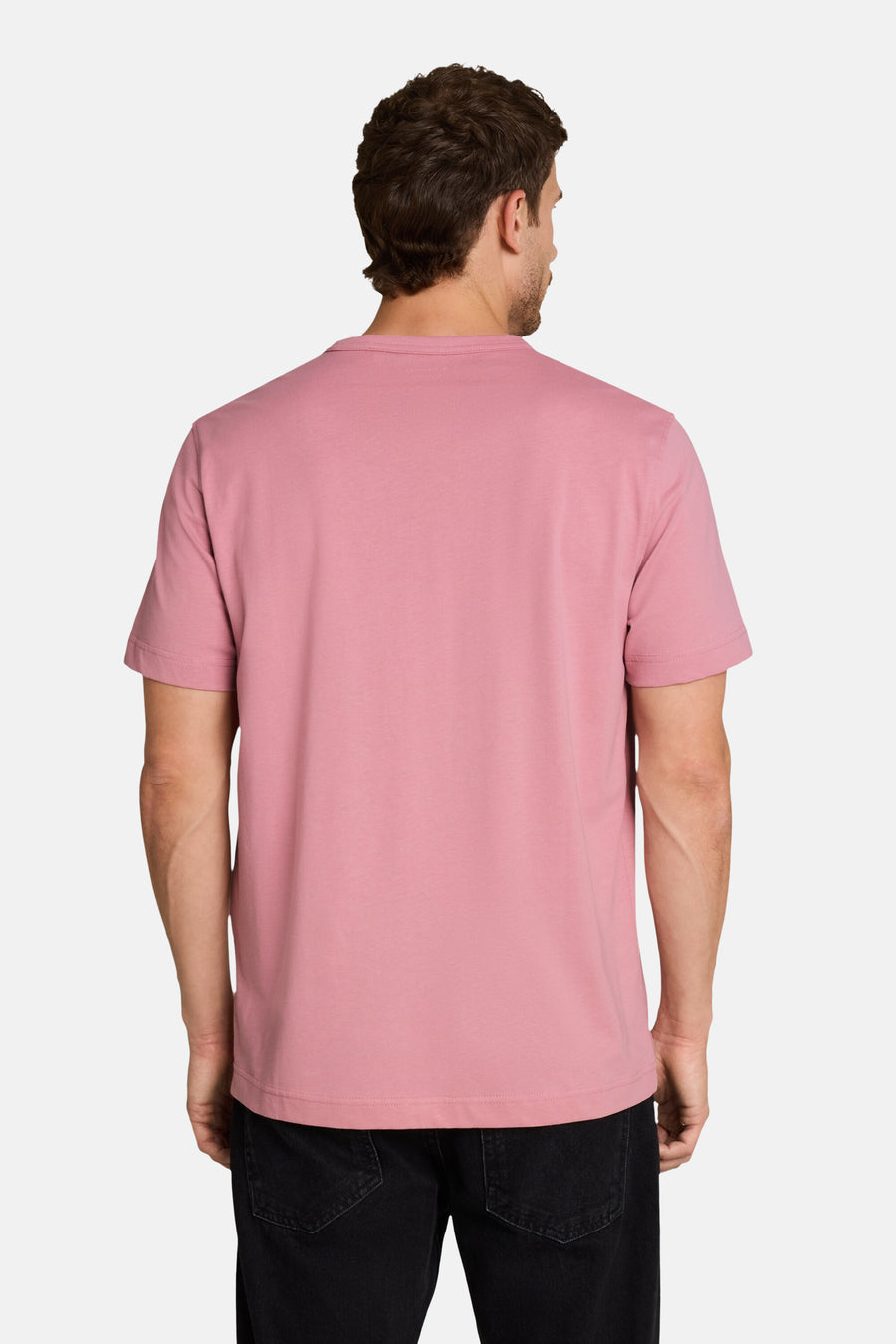 Rose short-sleeve t-shirt back view, soft cotton fabric, clean round neckline, worn with dark jeans