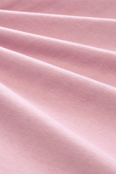 Soft pink short-sleeve t-shirt fabric close-up, smooth texture with gentle folds, solid color, soft cotton material.