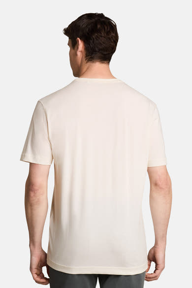 White short-sleeve t-shirt back view, plain cotton fabric, clean fit on model wearing dark pants