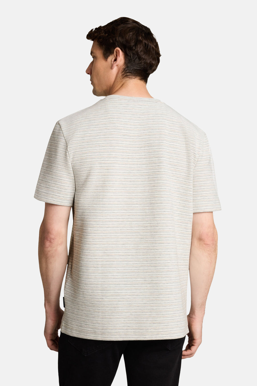 White short-sleeve t-shirt with fine horizontal stripes, back view, worn with dark jeans