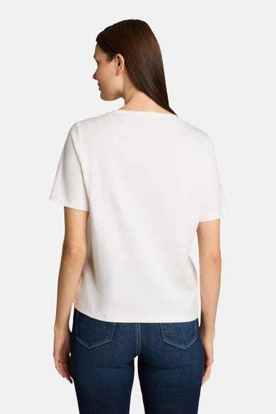 White short-sleeve t-shirt with round neckline, back view, worn with dark blue jeans