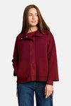 Burgundy cardigan with button front and side pockets, featuring striped cuffs and collar details, worn over a striped top with blue jeans, front view.