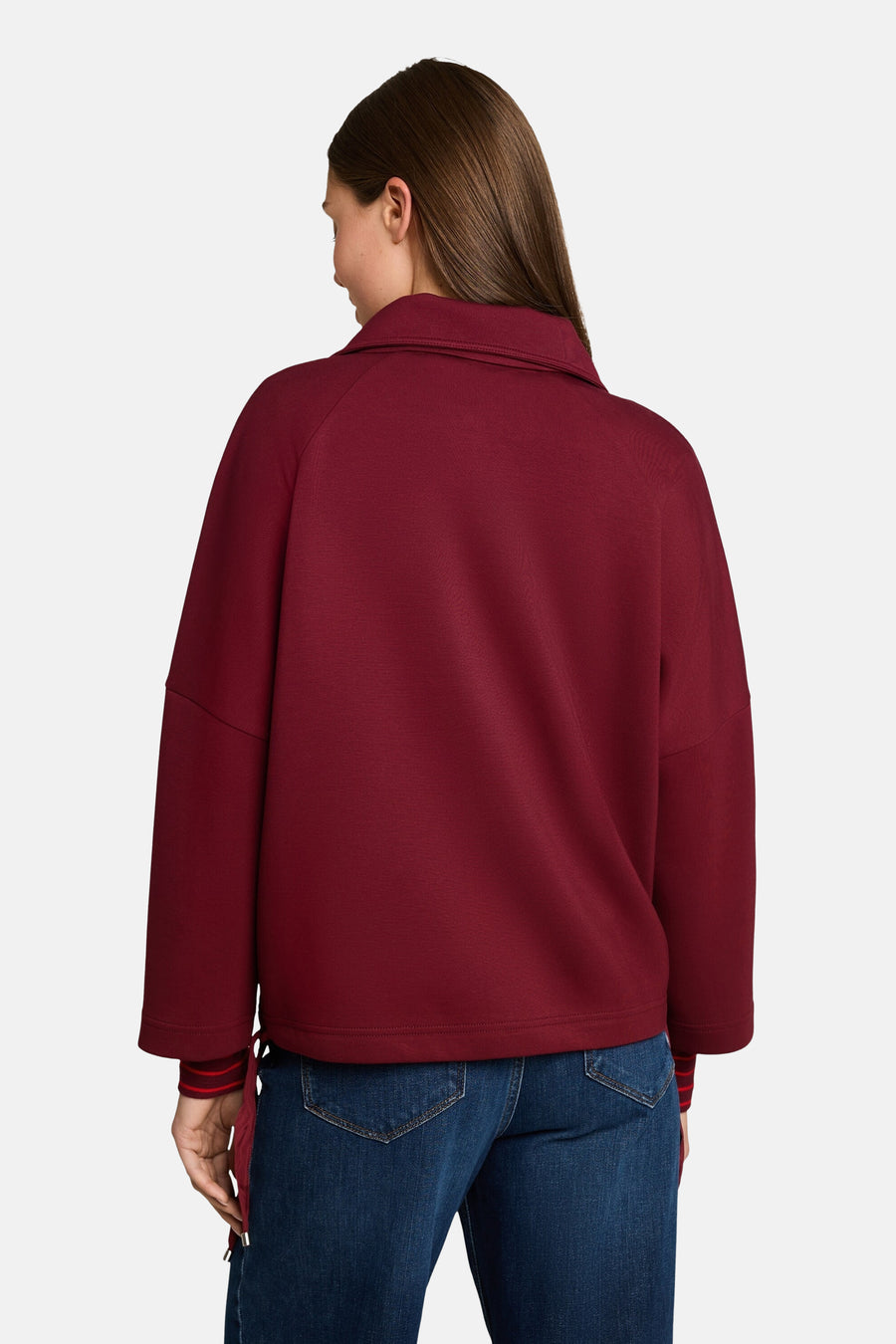 Burgundy cardigan with ribbed cuffs and collar, back view, worn with blue jeans