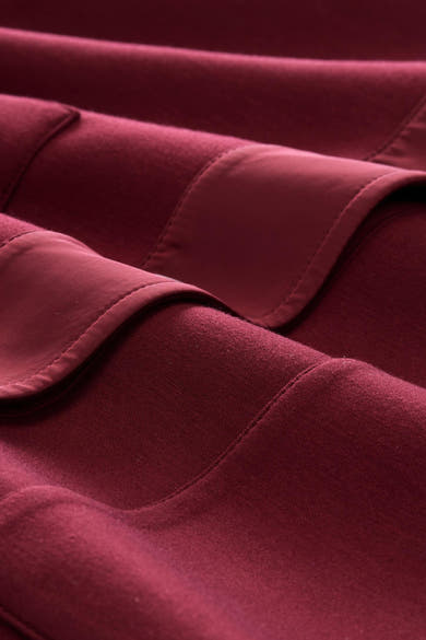 Rouge cardigan with soft textured fabric and detailed stitching, close-up view showing rich color and material texture