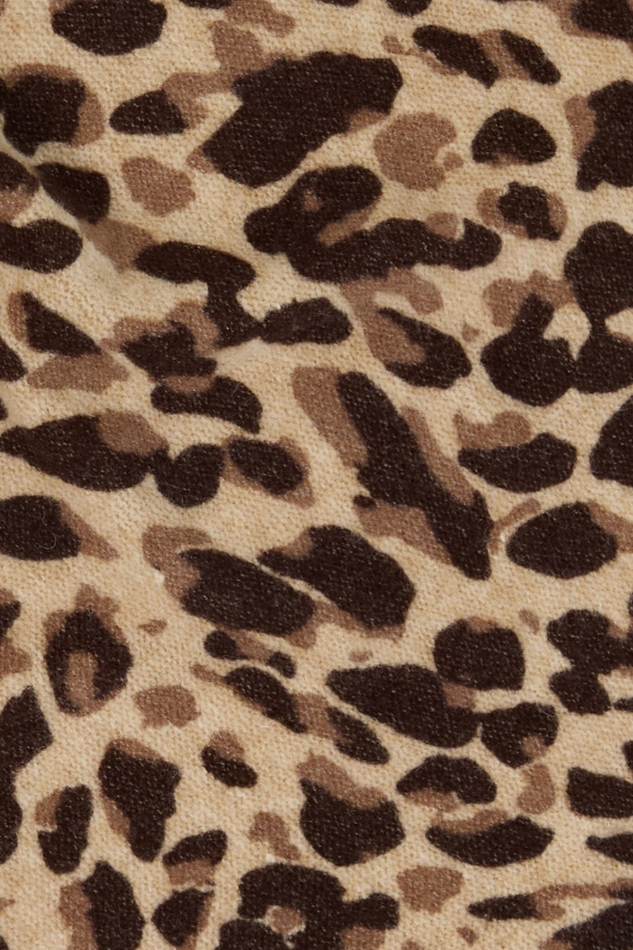 Multicolored leopard print scarf by Tom Tailor, featuring beige base with brown and black spots, textured knit fabric, close-up view
