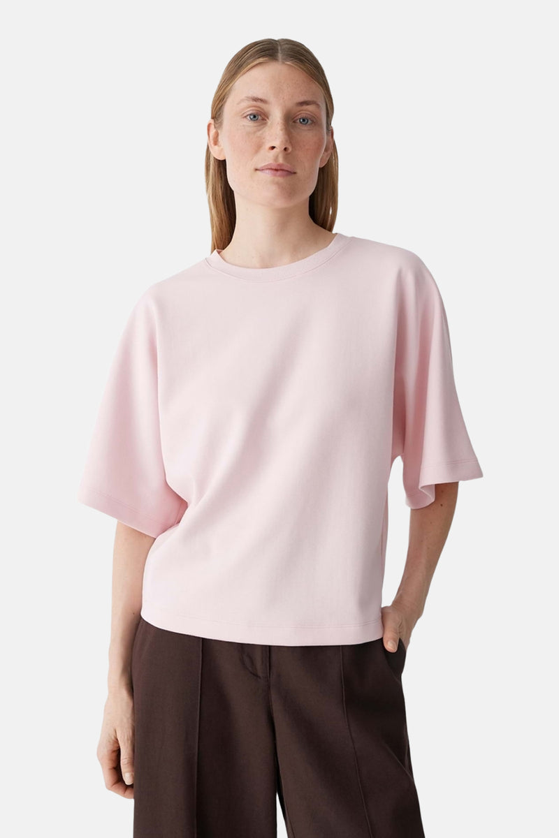 T-shirt rose d'OPUS à col rond et manches courtes évasées, porté avec un pantalon marron.