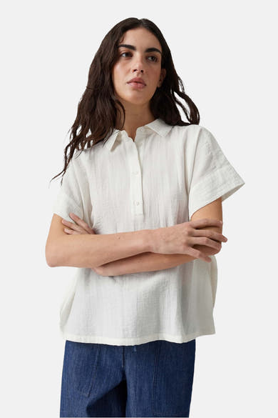 Yellow sleeveless blouse with button-down front and relaxed fit, worn with dark denim pants, front view.