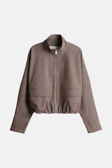 Brown bomber jacket with front zipper and two flap pockets, cropped fit, textured fabric, studio front view