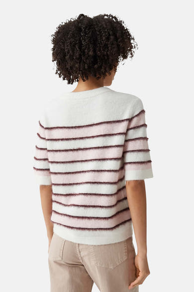 Multicolored round-neck sweater with white, pink, and burgundy horizontal stripes, soft textured knit, back view on model wearing beige pants