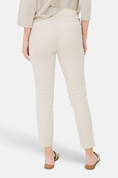 Beige slim-fit jeans by PAMINA 68, back view, with clean stitching and straight leg, worn with neutral top and sandals