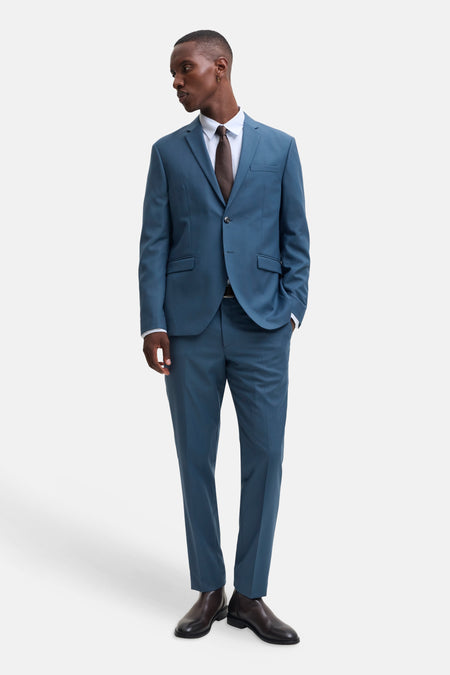Blue tailored suit pants by JACK & JONES, slim fit with clean lines, worn with matching blazer and brown leather shoes, full-length front view.