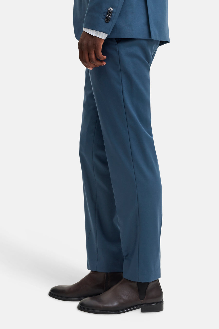 Blue tailored suit pants by JACK & JONES, side view, smooth fabric, slim fit with matching blazer and brown leather boots.