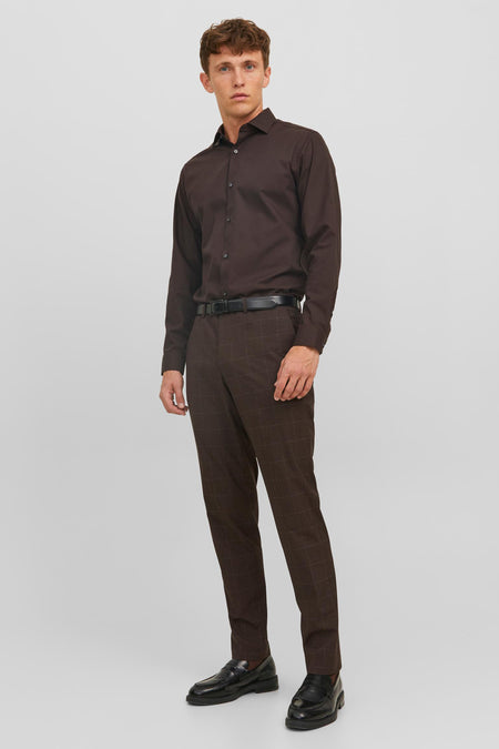 Bruine kostuumbroek van PREMIUM by JACK & JONES, geruit, gedragen met een overhemd en zwarte schoenen.