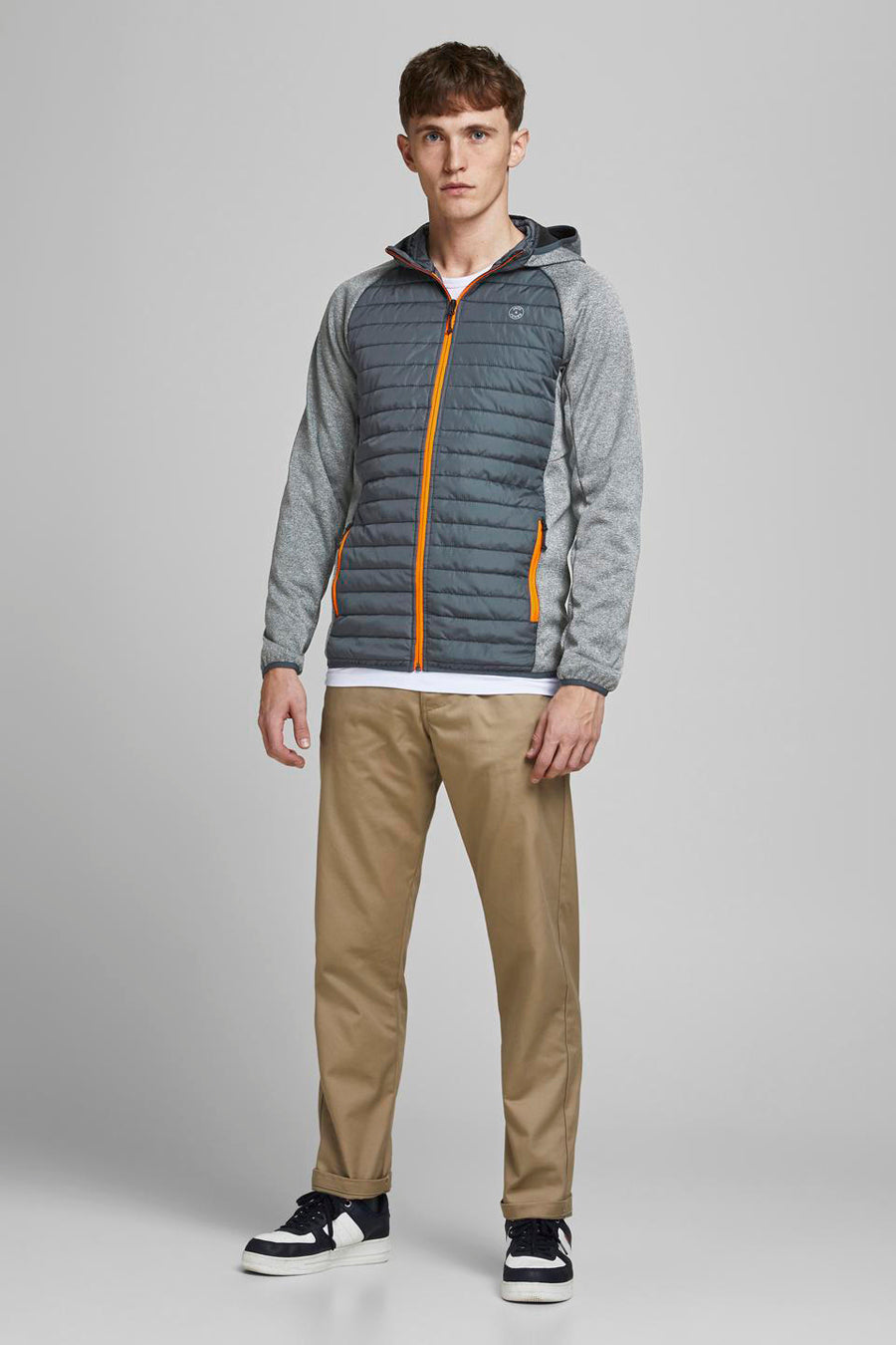 Grijze waterdichte jas van JACK & JONES met oranje ritssluiting, capuchon en lange gemêleerde grijze mouwen.