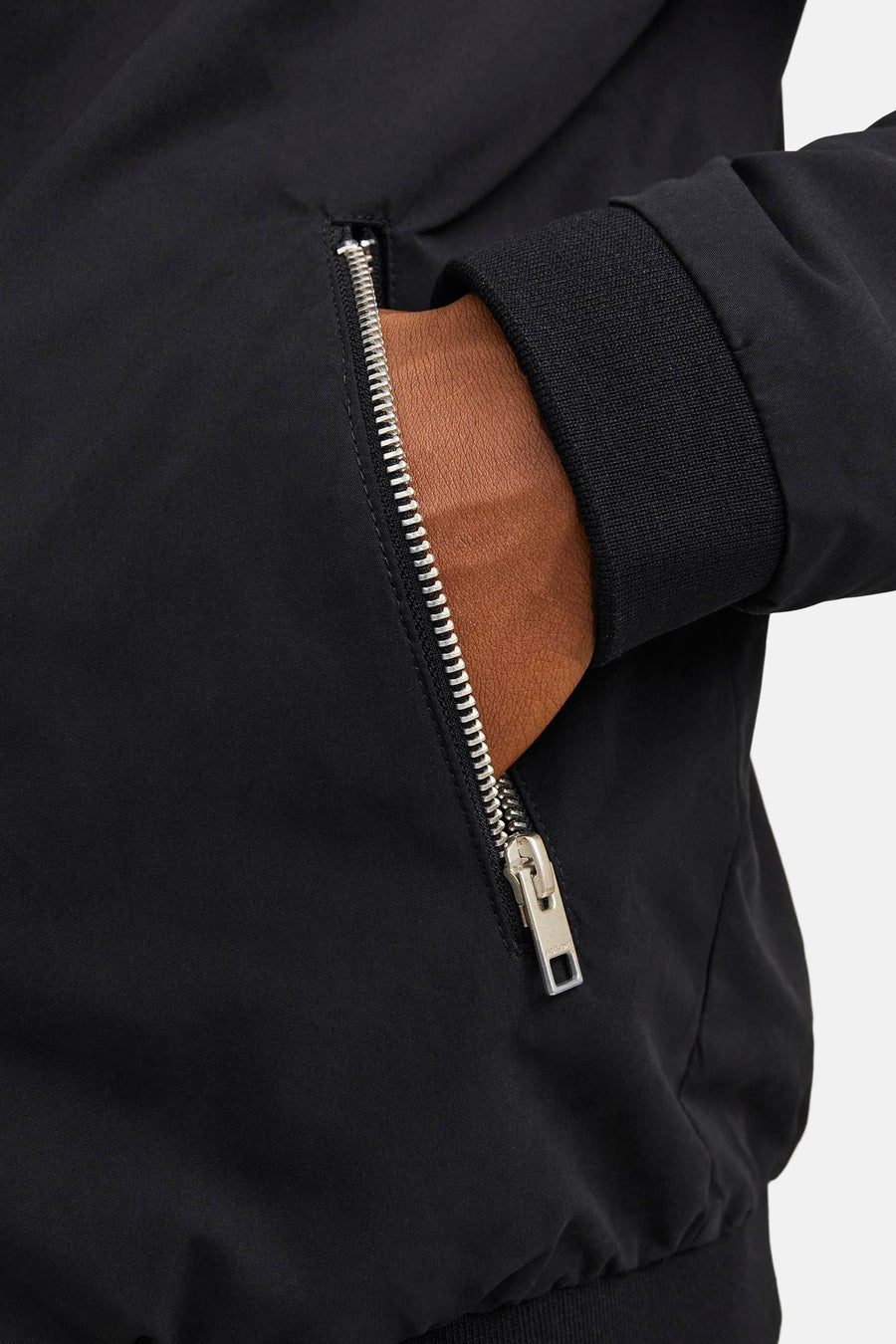 Korte zwarte jas van JACK & JONES met zilveren ritssluiting en geribbelde manchetten.