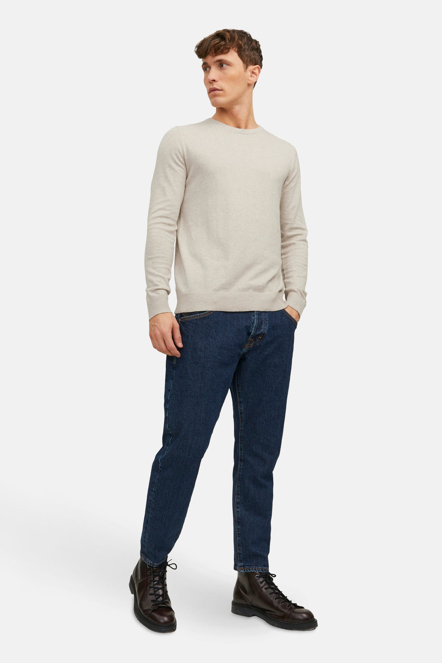 Pull col O beige de PREMIUM BLUE by JACK & JONES, porté avec un jean bleu foncé et des bottes en cuir marron.