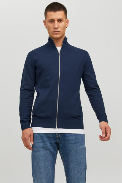 Navy blue knit gilet with full front zipper and ribbed cuffs, worn over white t-shirt with blue jeans, front view