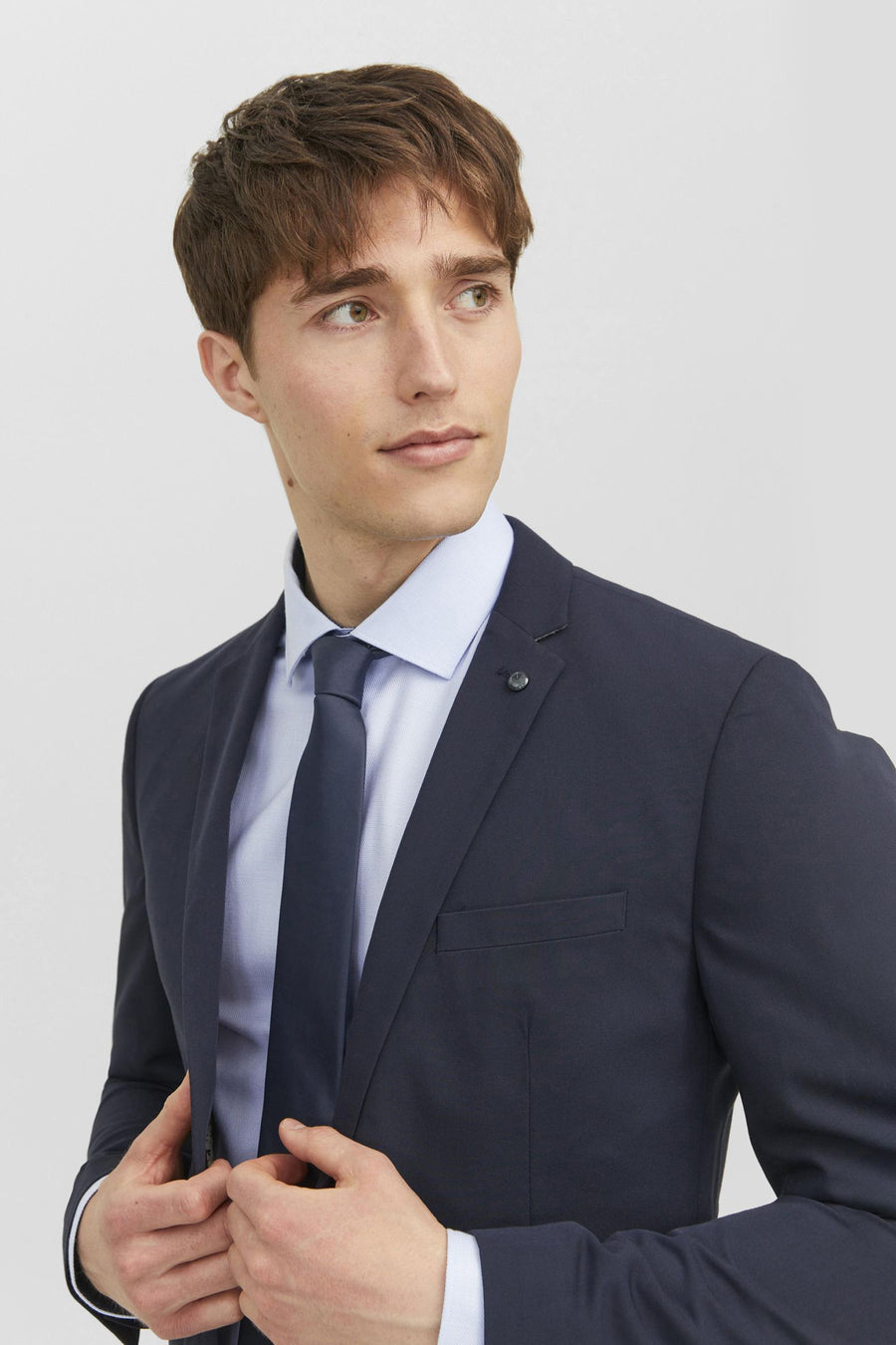 Cravate bleue de ACCESSORIES BY JACK & JONES, portée avec une chemise bleu clair et un costume bleu marine.