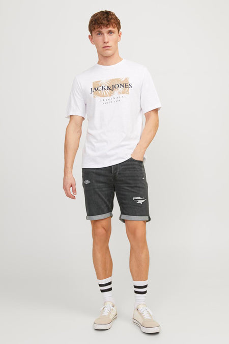 Zwarte spijkerbroekshorts van JACK & JONES, met gescheurde details en omgeslagen zoom, gedragen met een wit T-shirt.