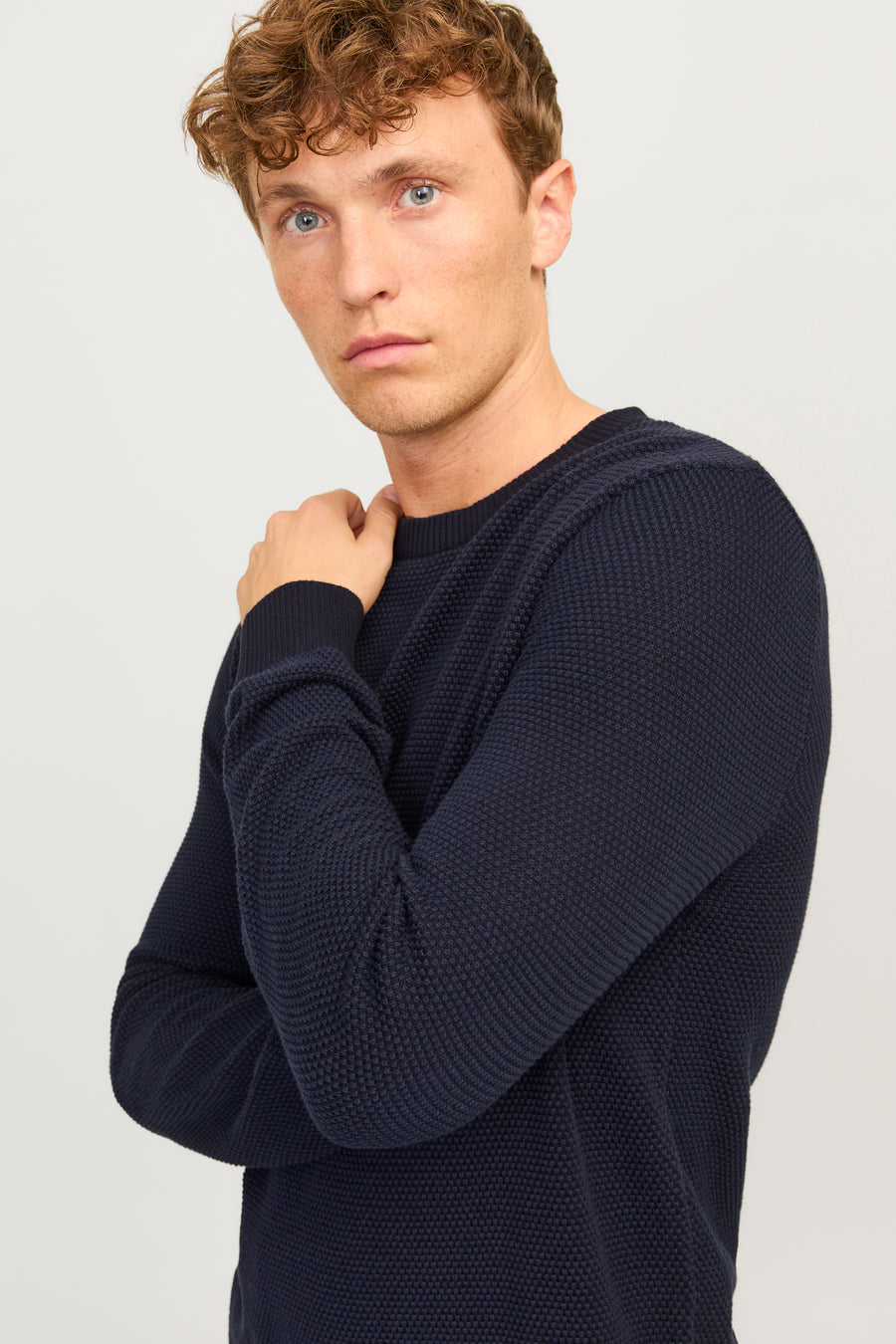 Pull bleu à col rond de JACK & JONES, texture tricotée visible et manches longues.