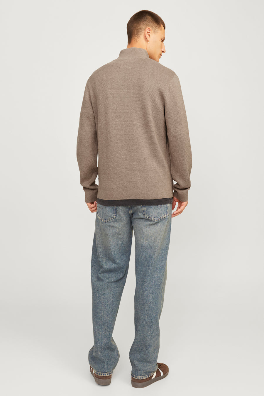 Pull à col roulé beige de PREMIUM by JACK & JONES, porté avec un jean bleu ample et des chaussures marron.