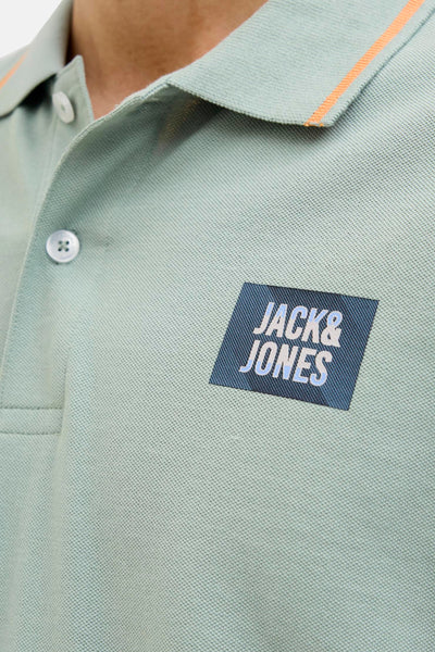 Polo kaki à manches courtes de JACK & JONES, avec bordure orange au col et logo sur la poitrine.
