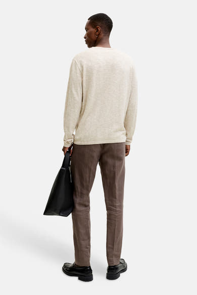 Pull à col rond beige de PREMIUM by JACK & JONES, porté avec un pantalon marron et des mocassins noirs.