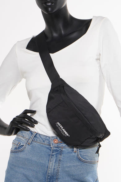 Zwarte schoudertas van Accessories by Jack & Jones gedragen met een lichtblauwe jeans en een wit T-shirt