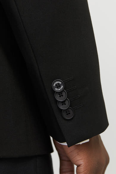 Blazer noir par PREMIUM by JACK & JONES, avec quatre boutons décoratifs sur la manche.
