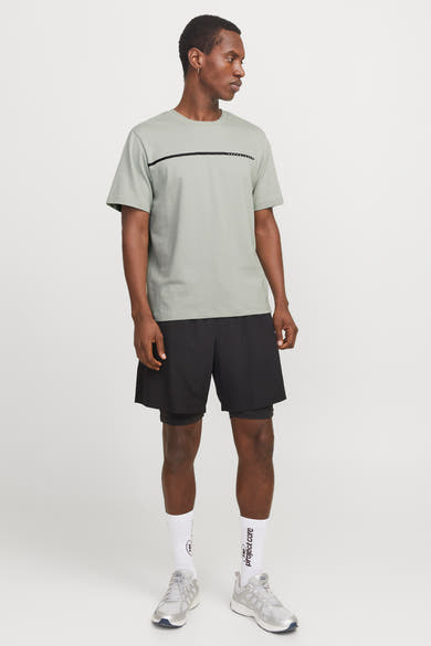 T-shirt à manches courtes vert par JACK & JONES, avec rayure horizontale sur le devant, porté avec un short noir.
