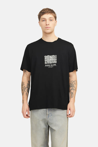 Zwart T-shirt met korte mouwen van ORIGINALS BY JACK & JONES, met een grafische print op de borst, gedragen met een lichte spijkerbroek.